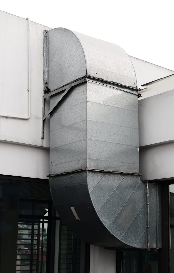 who-we-are-img Close-up of a contemporary ventilation duct exterior in a city setting.